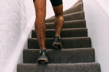 Close up of a man running up stairs at home.